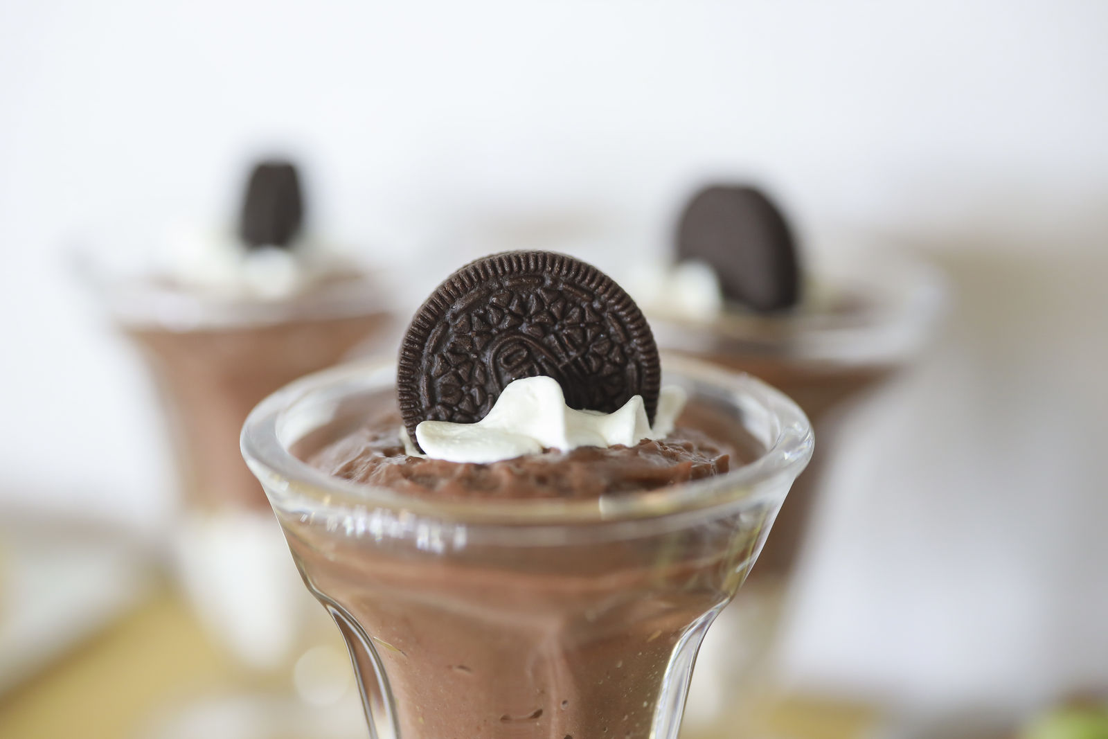 This is a dessert in a glass. Chocolate pudding with cream and a oreo cookie on top.